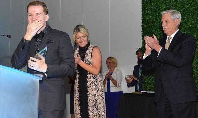 Anthony Melf, PA CareerLink, stands stunned at the podium as he accepted the 2019 Young Professional Inspiration Award presented by Lindsey Griffin, Wilkes-Barre Chamber of Commerce CEO and Vice President, and Mike Murray, Times Leader Media Group's publisher. - - Tony Callaio | For Times Leader