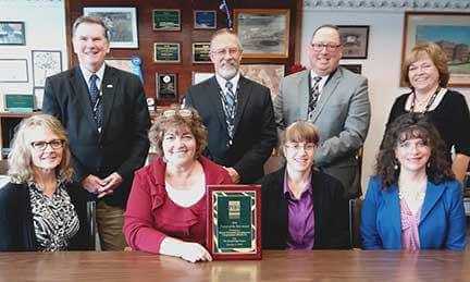 Wayne County Commissioners Wendell Kay, standing left, Brian Smith and Joe Adams, and chief clerk Vicky Botjer are pictured on October 4 accepting the Project of the Year Award from Susan Shaffer, seated left, Mary Beth Wood, Jess Wolk and Helene Mancuso, presented by the PA Economic Development Association on October 2.