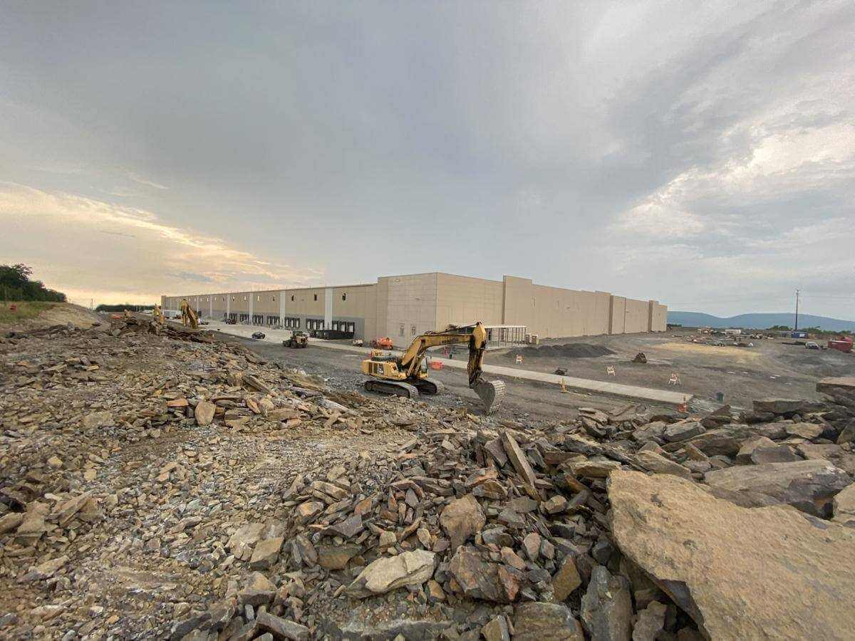 A vast structure rises on the hilltop along Archbald Heights Drive in Archbald. Chewy, the online pet supply retailer, is nearing completion of a 1 million-square-foot distribution center. - JON O'CONNELL / STAFF PHOTO