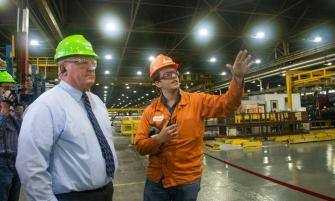 DAVID MCKEOWN / STAFF PHOTOGRAPHER Pascual Rocco, right, process engineer at Hydro Extrusion USA LLC in Cressona, gives a tour of the plant Tuesday to U.S. Rep. Glenn Thompson, R-5.