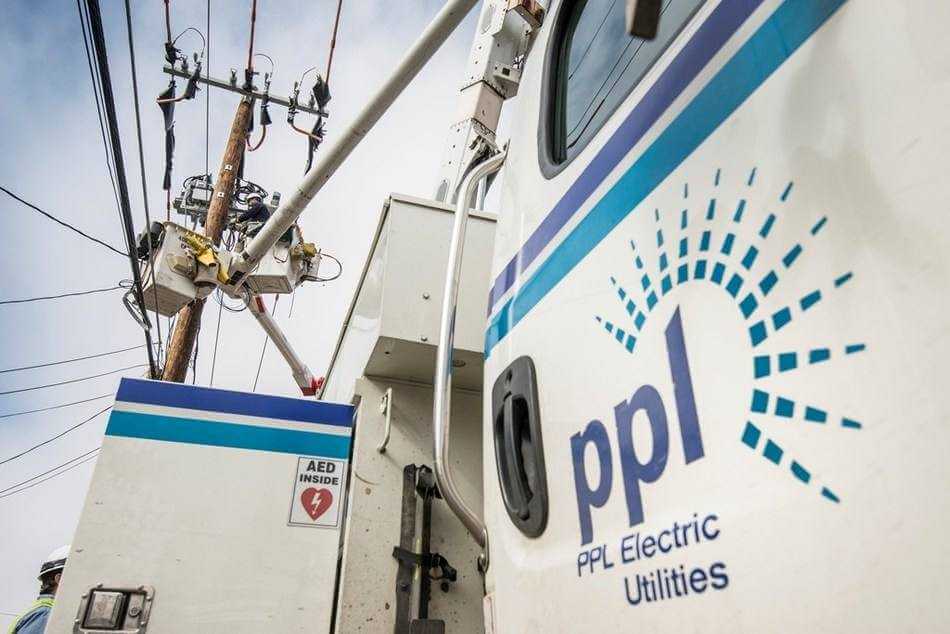 A PPL Electric Utilities lineworker installs smart grid equipment on distribution lines.
