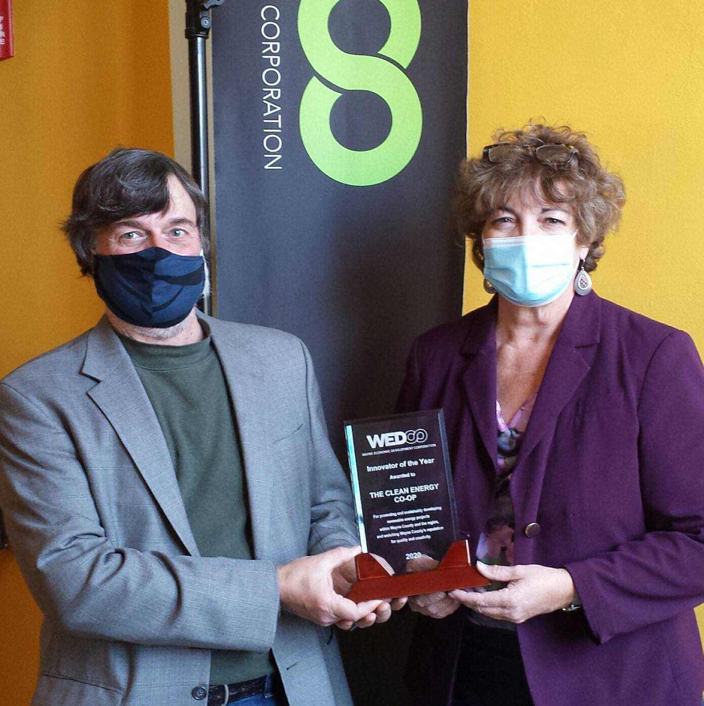 Shown left to right:  Jack Barnett, a Director of The Clean Energy Co-op, accepting WEDCO's Innovator of the Year Award from WEDCO executive director Mary Beth Wood.
