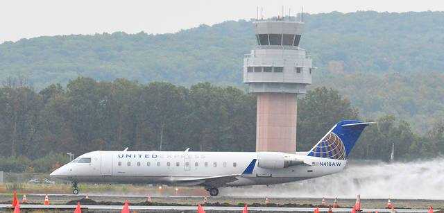 United Express flight 3899 speeds down the runway at the Wilkes-Barre/Scranton International Airport past the control tower Thursday for its 2:10 p.m. daily flight to Washington Dulles Airport. United is now offering two daily non-stop, round-trip flights to Washington, D.C. - Tony Callaio | For Times Leader